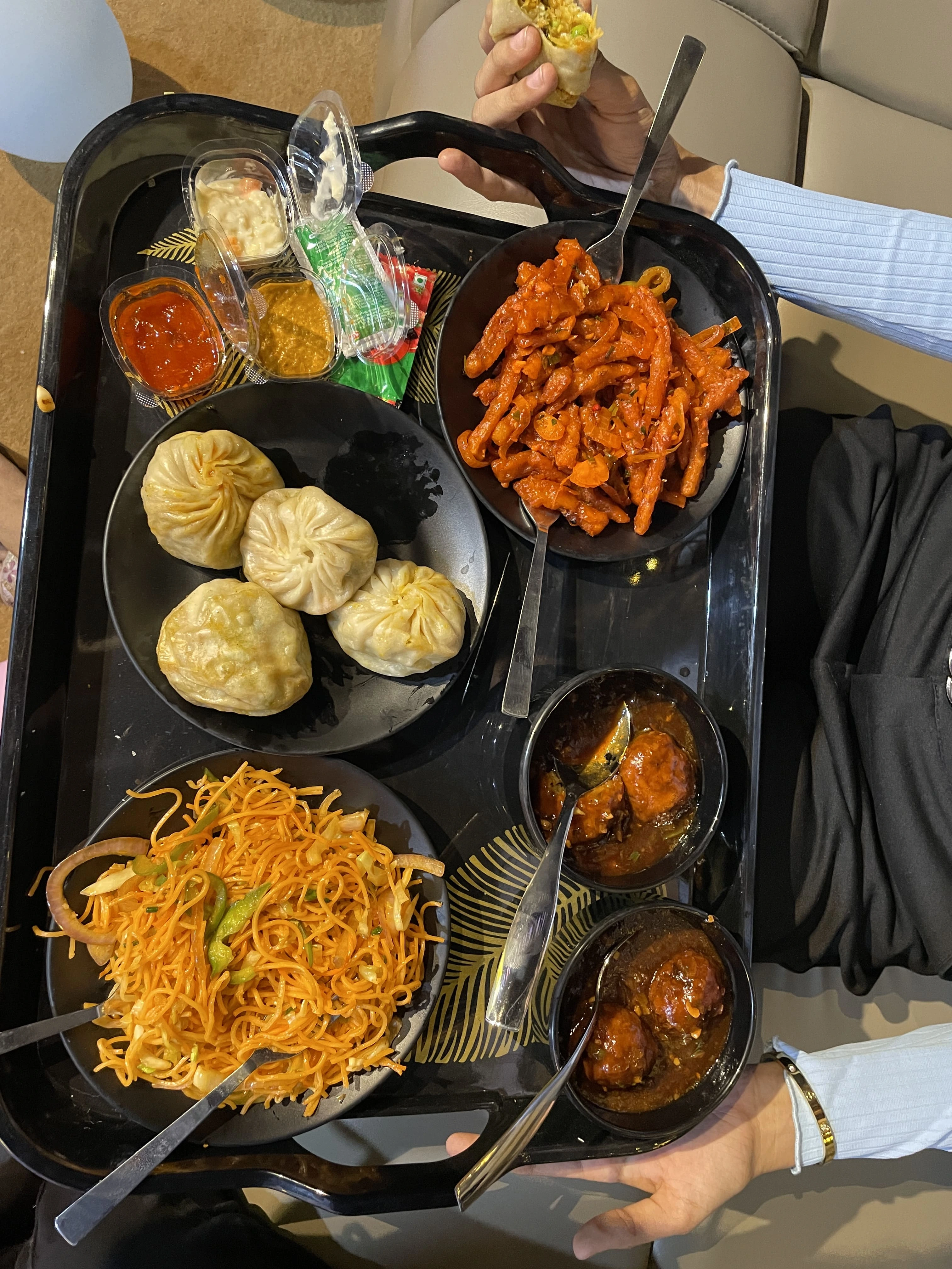 Group of friends enjoying a party with drinks and food